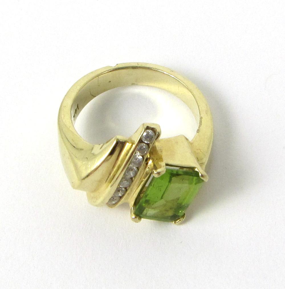 Appraisal: PERIDOT DIAMOND AND FOURTEEN KARAT GOLD RING channel set with