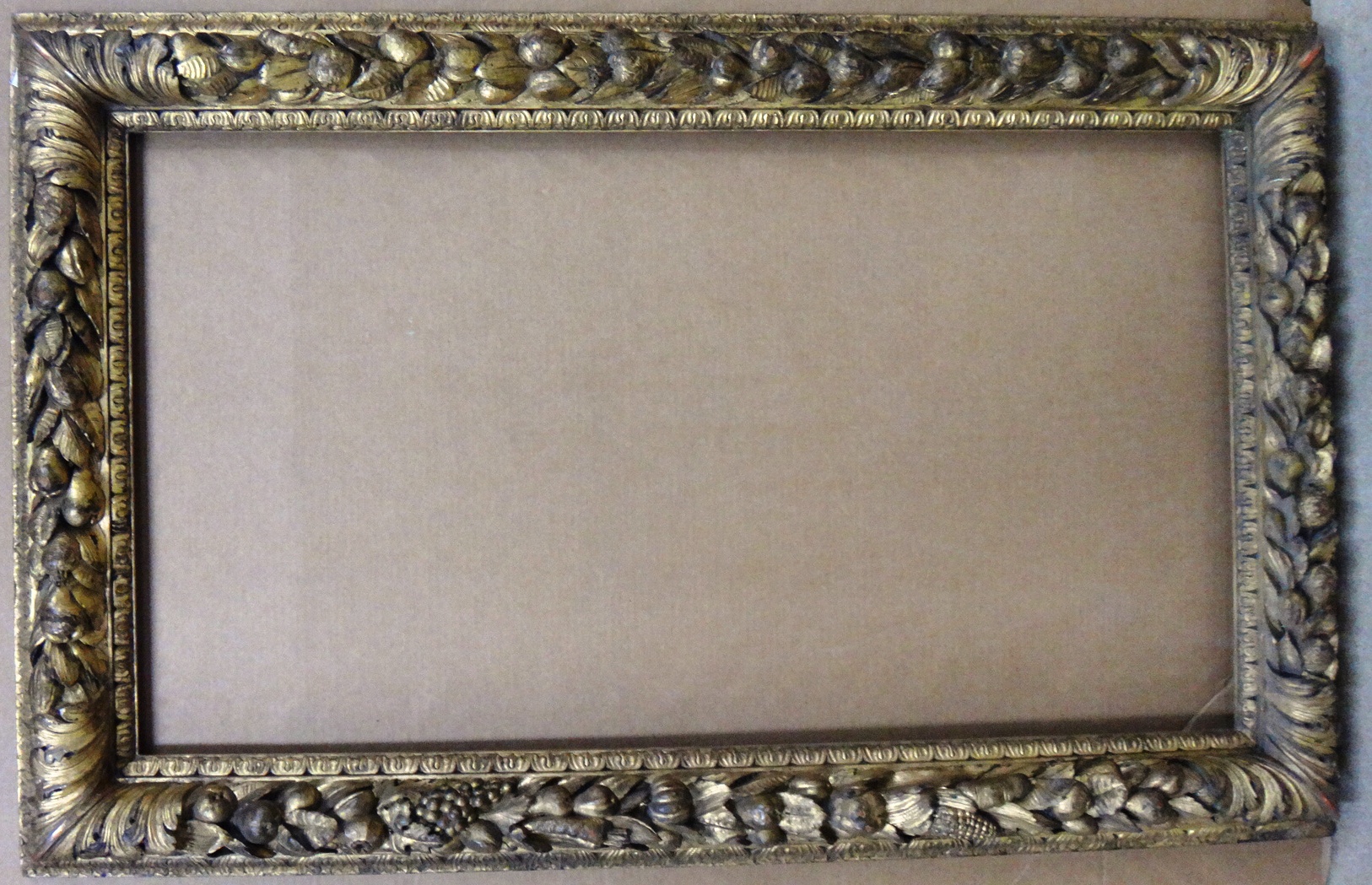 Appraisal: A th century and earlier carved giltwood frame with fruit