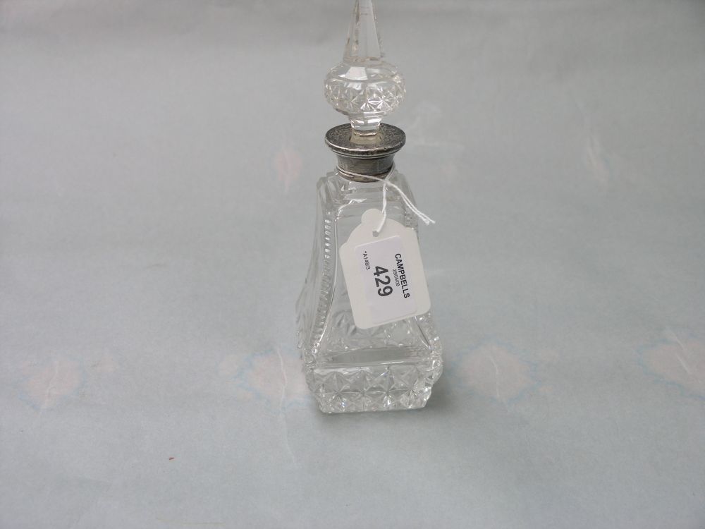 Appraisal: A cut glass scent bottle with engraved detail spire stopper