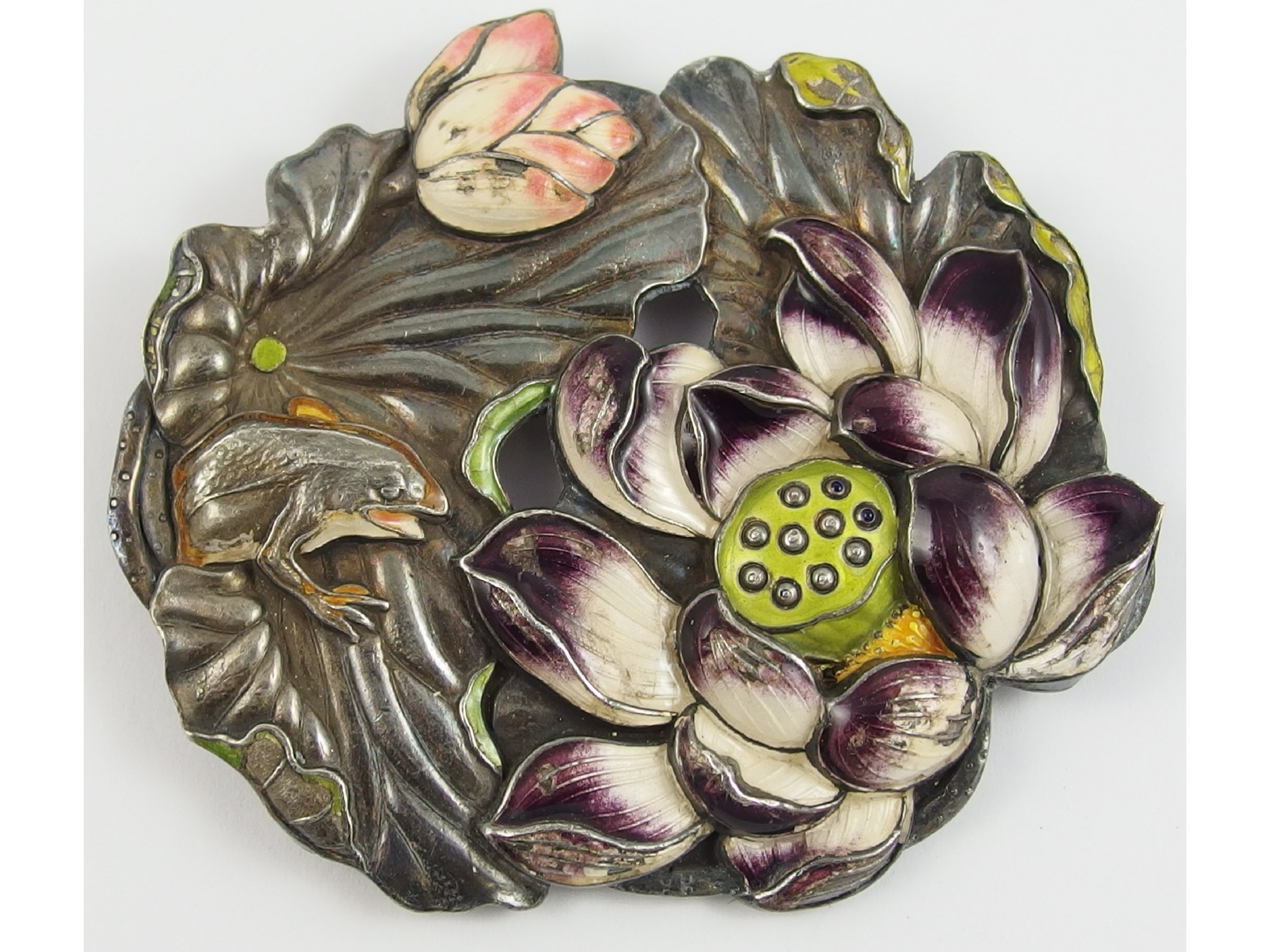 Appraisal: An oriental white metal frog and lotus flower buckle enamelled