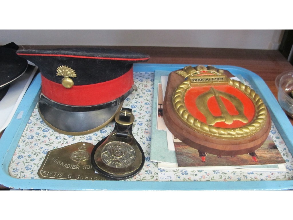 Appraisal: A lot comprising a military cap two military brass plaques