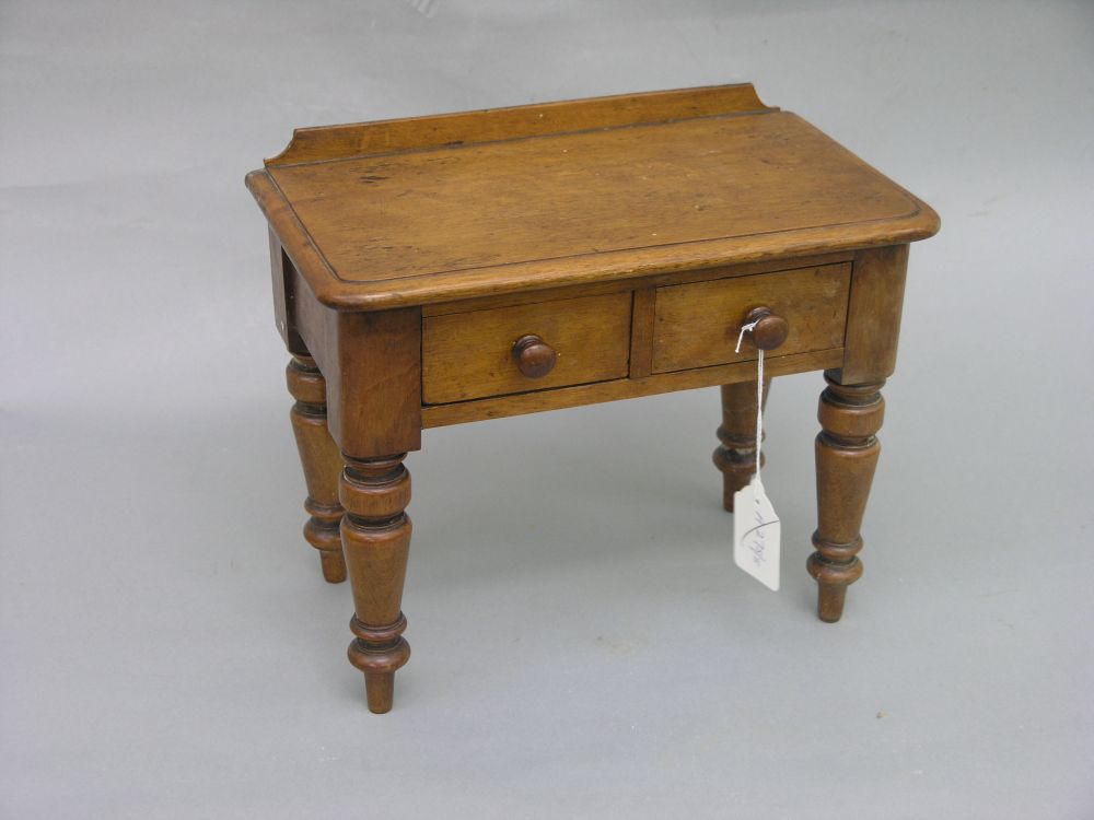 Appraisal: A Victorian miniature mahogany writing table with two frieze drawers