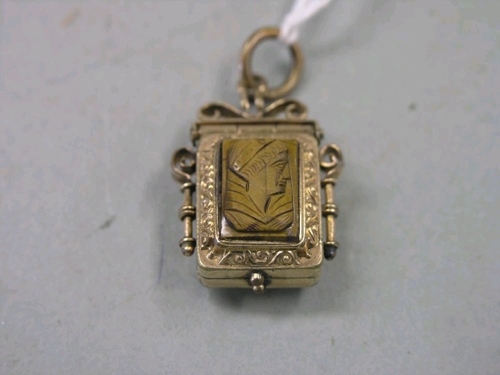 Appraisal: A gold-coloured metal locket the front carved with a portrait