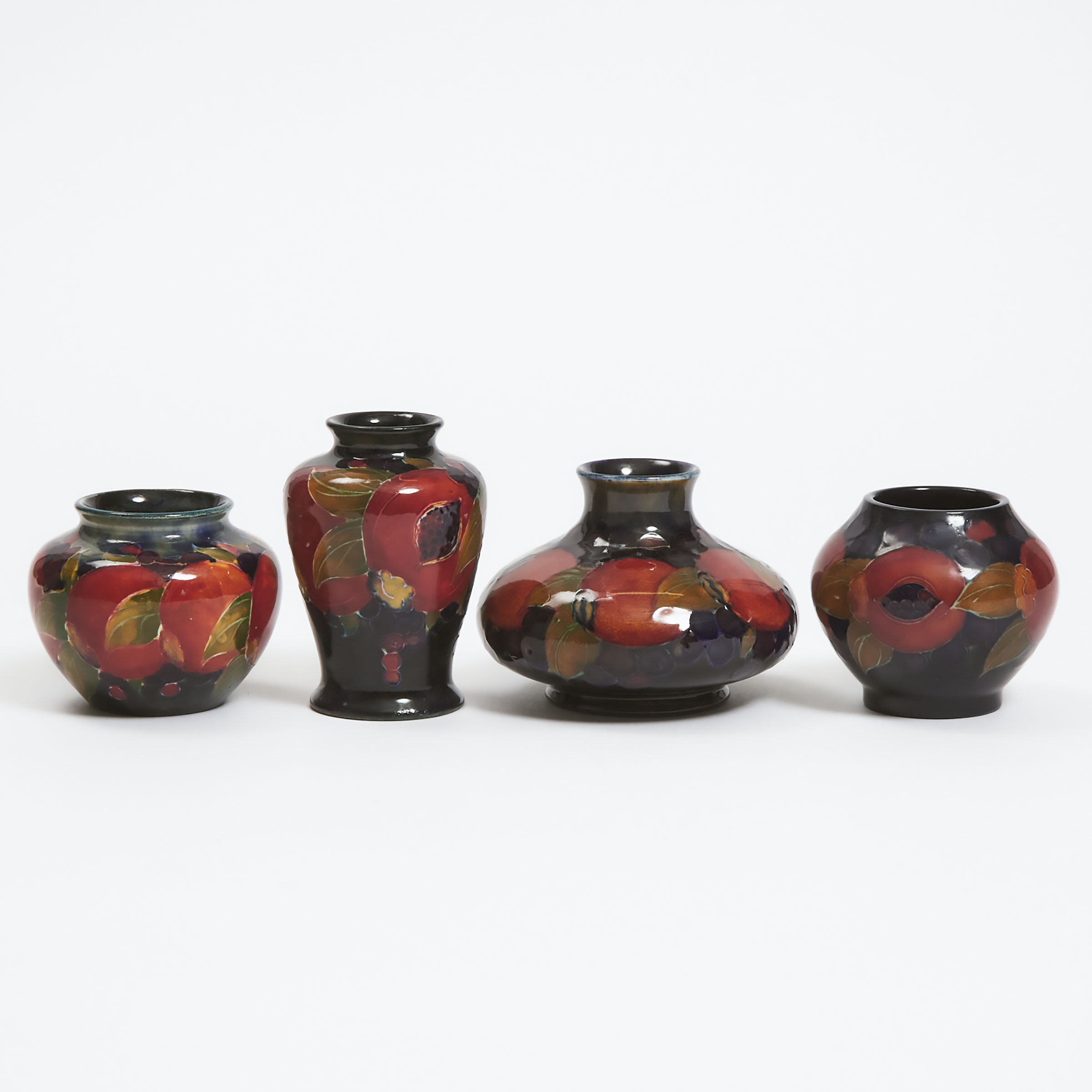 Appraisal: Four Moorcroft Small Pomegranate Vases c - largest height in