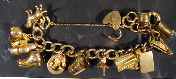 Appraisal: ct gold charm bracelet set with fifteen assorted charms approx