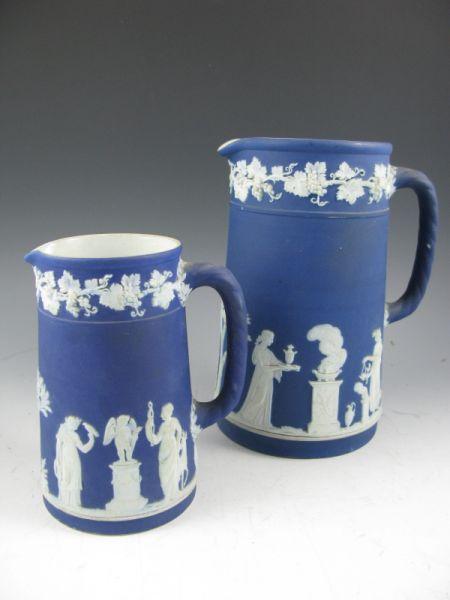 Appraisal: Two Wedgwood Blue Jasperware Pitchers The larger pitcher with a