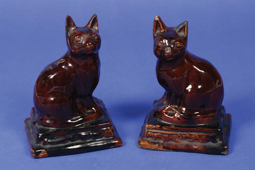 Appraisal: A PAIR OF TH CENTURY TREACLE GLAZED STAFFORDSHIRE ORNAMENTS in