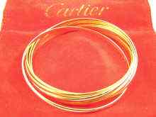 Appraisal: A French hallmarked three colour carat gold bangle by Cartier