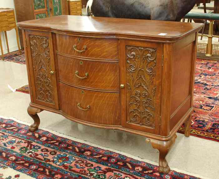 Appraisal: LATE VICTORIAN CARVED OAK BUFFET American late th century centering