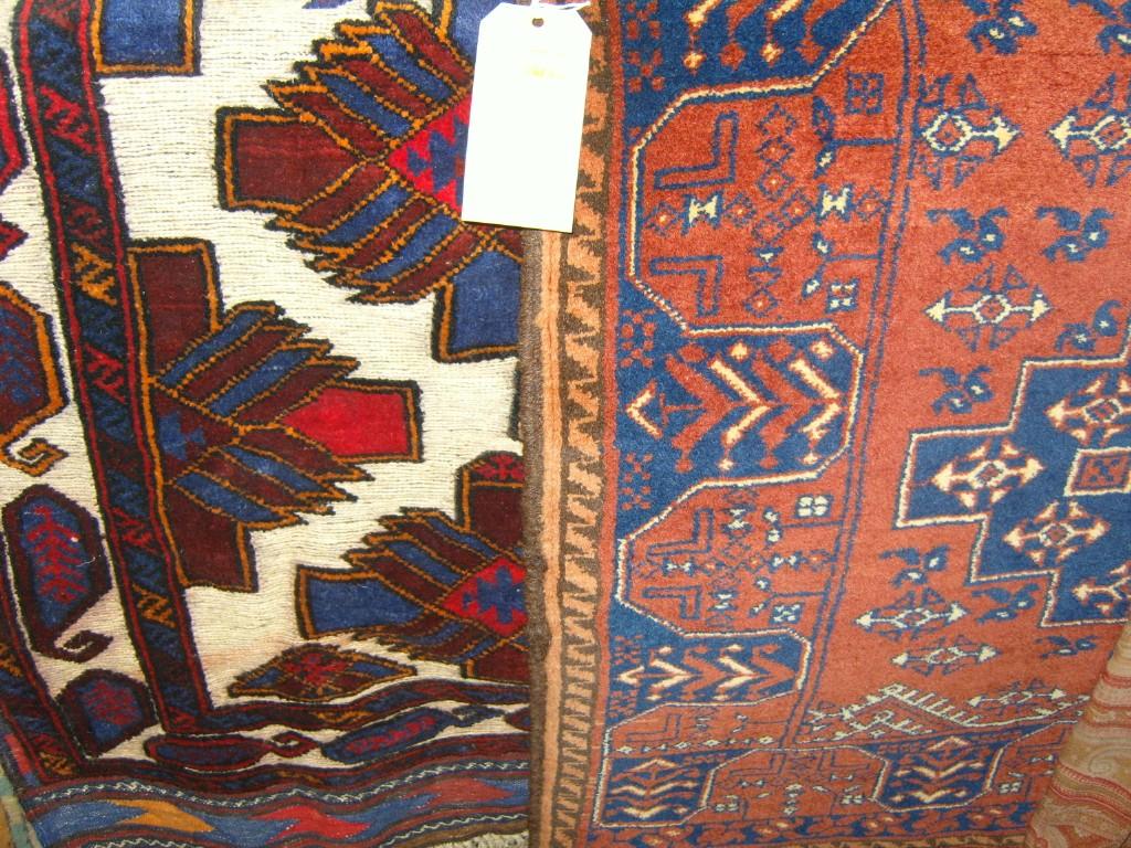 Appraisal: An eastern red ground wool rug with blue and cream