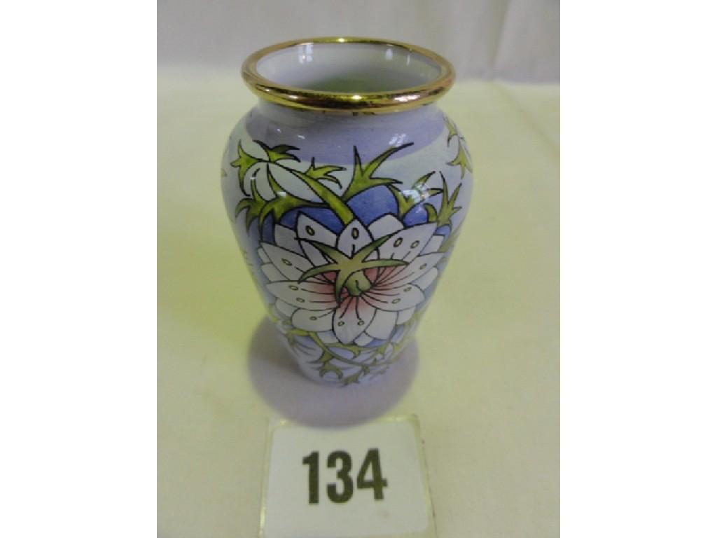 Appraisal: A small Moorcroft enamelled vase with stylised Love-in-a-Mist decoration and