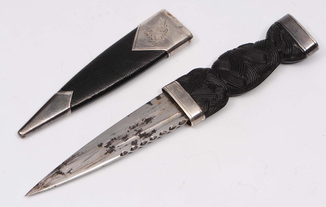 Appraisal: A Scottish silver mounted dirkwith geometric carved handle and leather