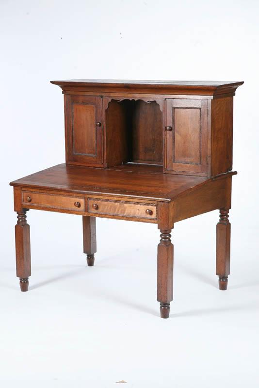 Appraisal: PLANTATION DESK Walnut with a molded cornice beaded doors and