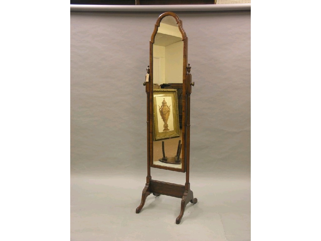 Appraisal: A walnut cheval mirror arched plate adjustable on turned stand