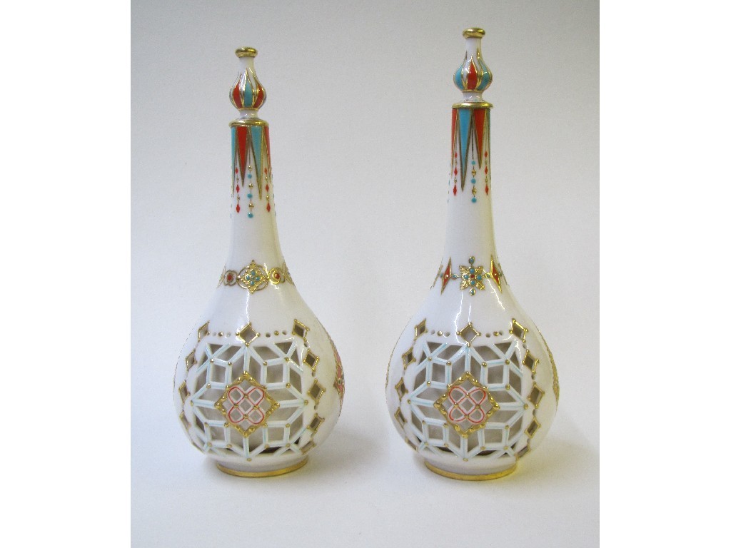 Appraisal: Two Royal Worcester reticulated bottle shaped vases of Persian design