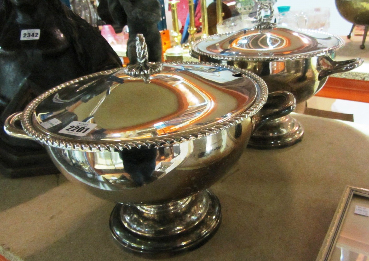 Appraisal: A pair of large silver plate twin handled lidded tureens