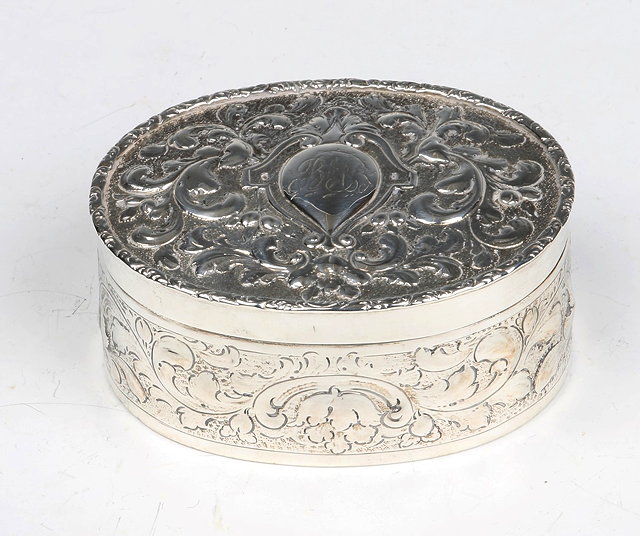 Appraisal: A GEORGE III OVAL SILVER TRINKET BOX with chased scroll