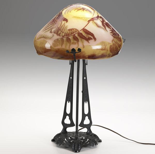 Appraisal: EMILE GALLETable lamp with fire-polished cameo glass shade on patinated