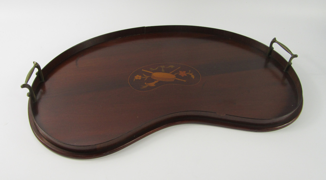 Appraisal: An Edwardian mahogany twin handled kidney shaped galleried tray with