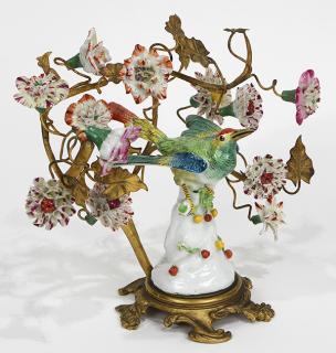 Appraisal: Continental ormolu mounted porcelain bird with flowers centering a colorful