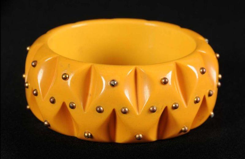 Appraisal: Bakelite Bracelet with Applied Brass Studs Description Deeply carved Condition