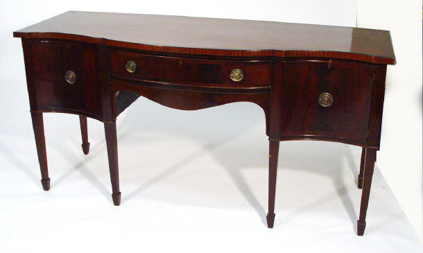 Appraisal: Mahogany serpentine fronted sideboard fitted a central drawer flanked by