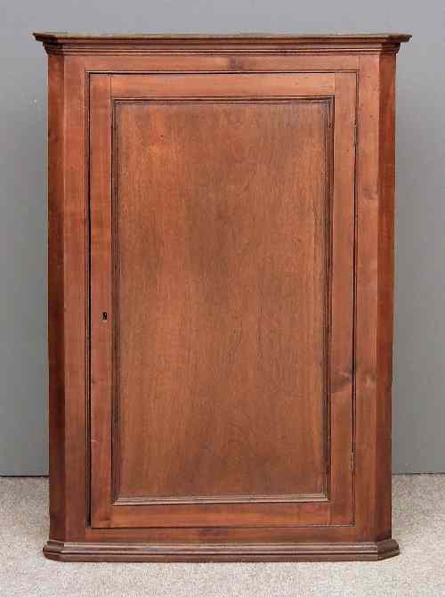 Appraisal: A th Century mahogany hanging corner cupboard fitted three shelves