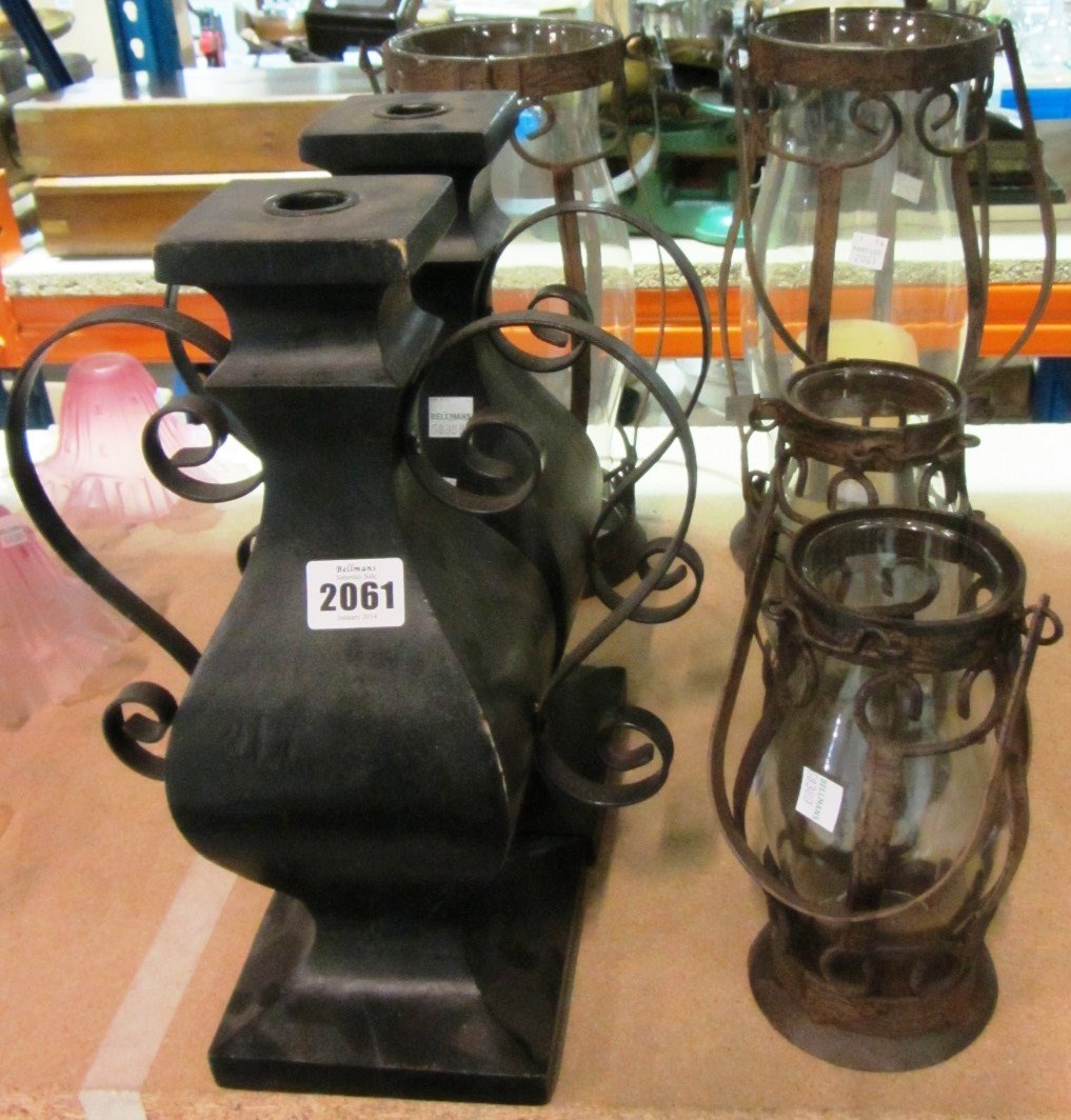 Appraisal: A pair of black painted candlesticks and four hanging lanterns