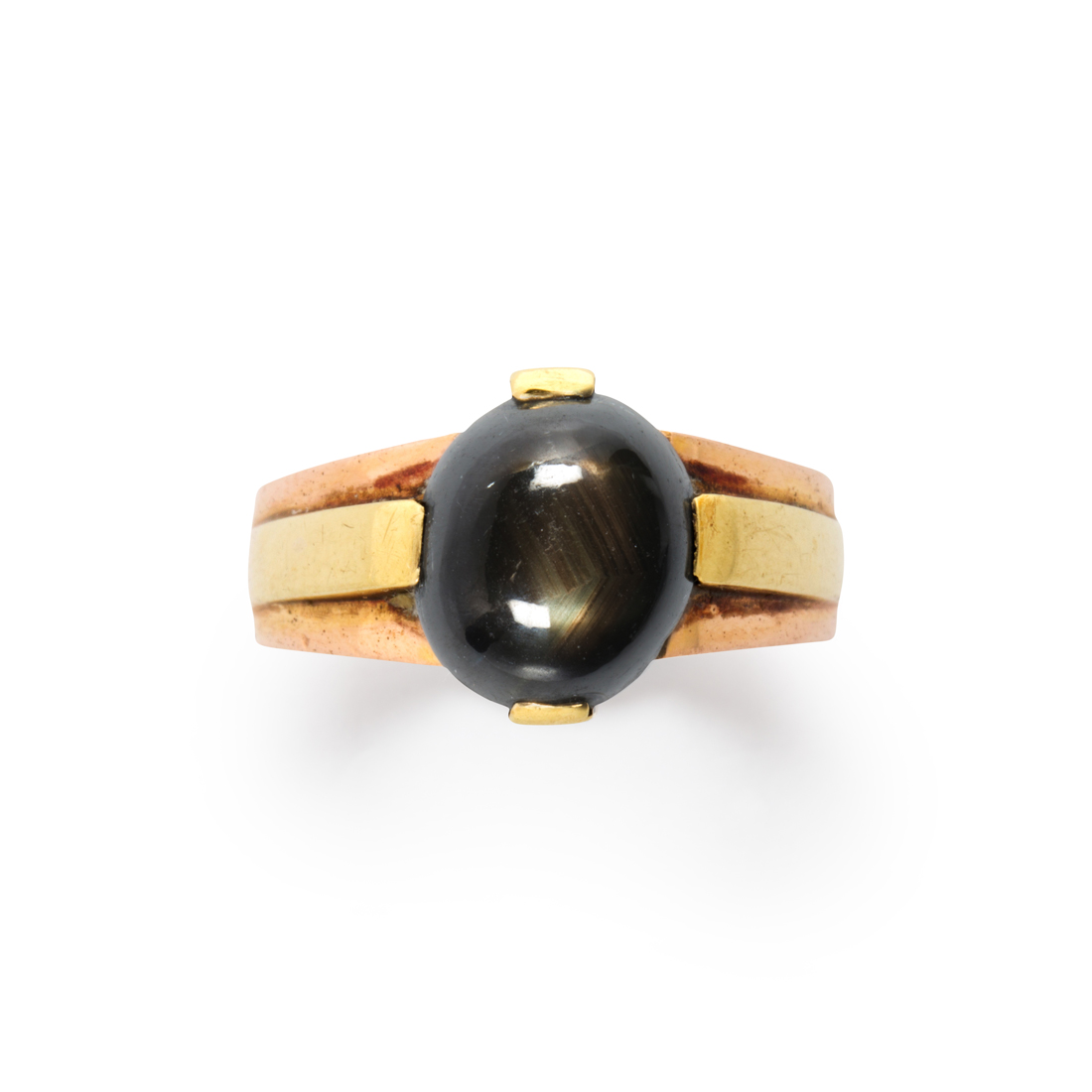 Appraisal: A BLACK STAR SAPPHIRE AND FOURTEEN KARAT BI-COLOR GOLD RING