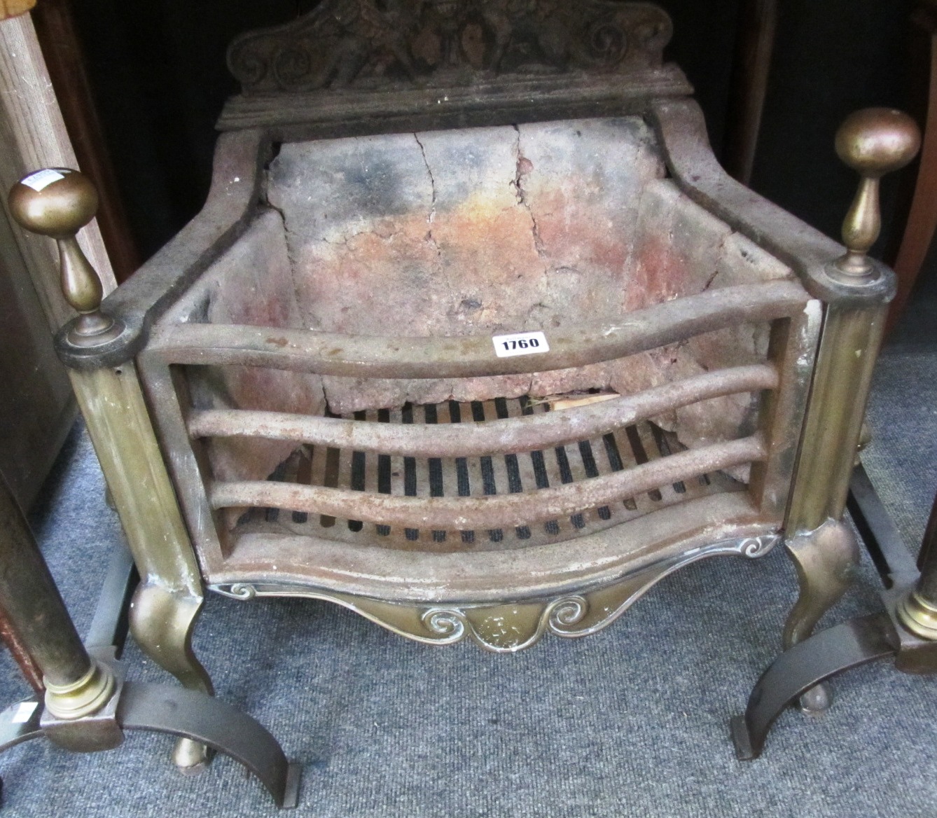 Appraisal: A cast iron and brass serpentine fire basket th century