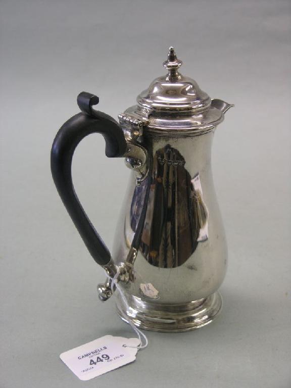 Appraisal: A Georgian style silver hot water pot with hinged cover