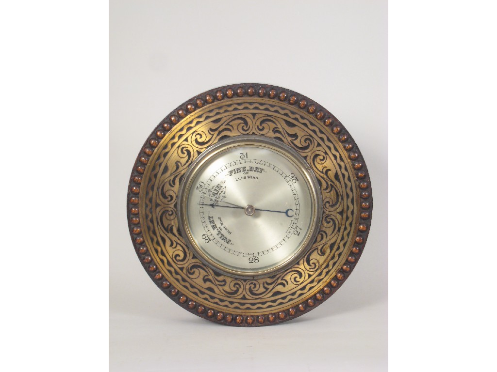 Appraisal: An oak framed circular Aneroid Barometer with brass scroll inlay