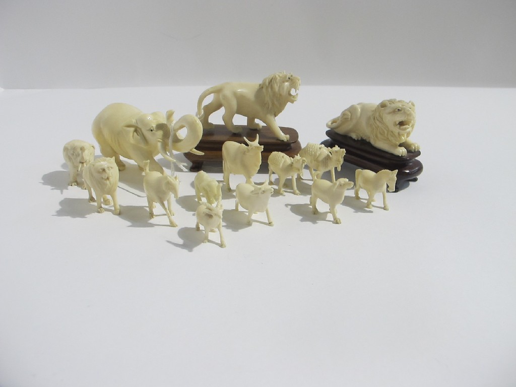 Appraisal: A lot comprising two carved ivory lion figures an elephant