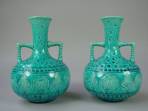 Appraisal: A pair of Burmantoft's twin handled tapered neck bottle vases