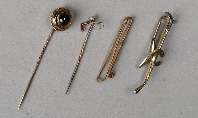 Appraisal: A GOLD AND DIAMOND SET STICK PIN in the form