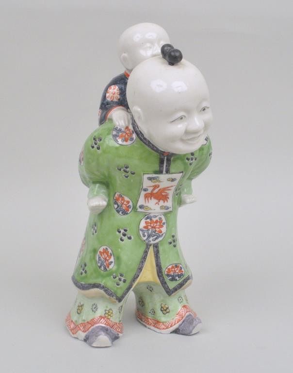 Appraisal: Chinese Enameled Porcelain Figure of a man carrying a boy