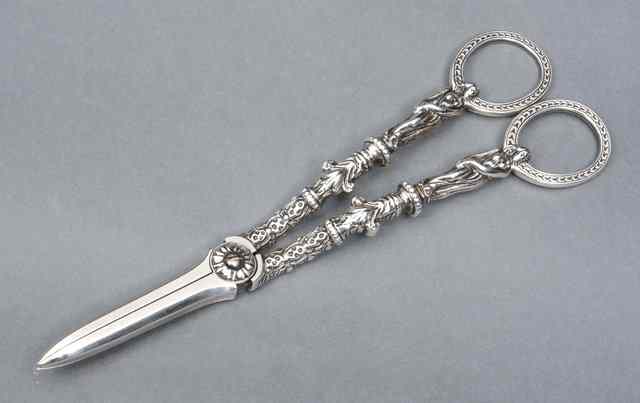 Appraisal: A PAIR OF VICTORIAN SILVER GRAPE SCISSORS the handles decorated