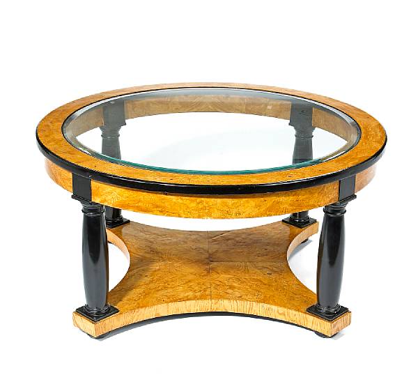 Appraisal: A Biedermeier style figured elmwood and parcel ebonized low table