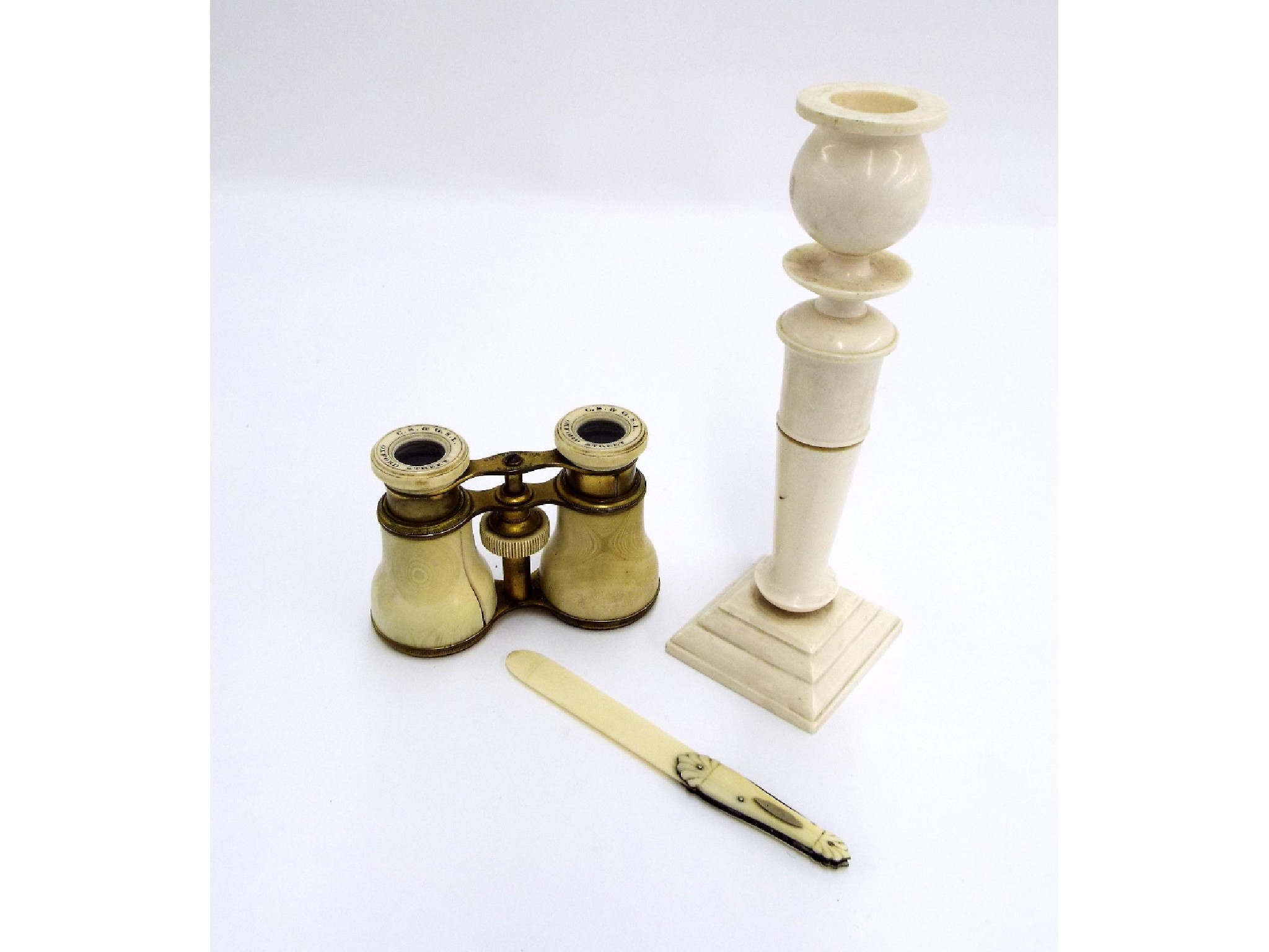 Appraisal: Pair of ivory opera glasses turned candlestick and ivory stationery