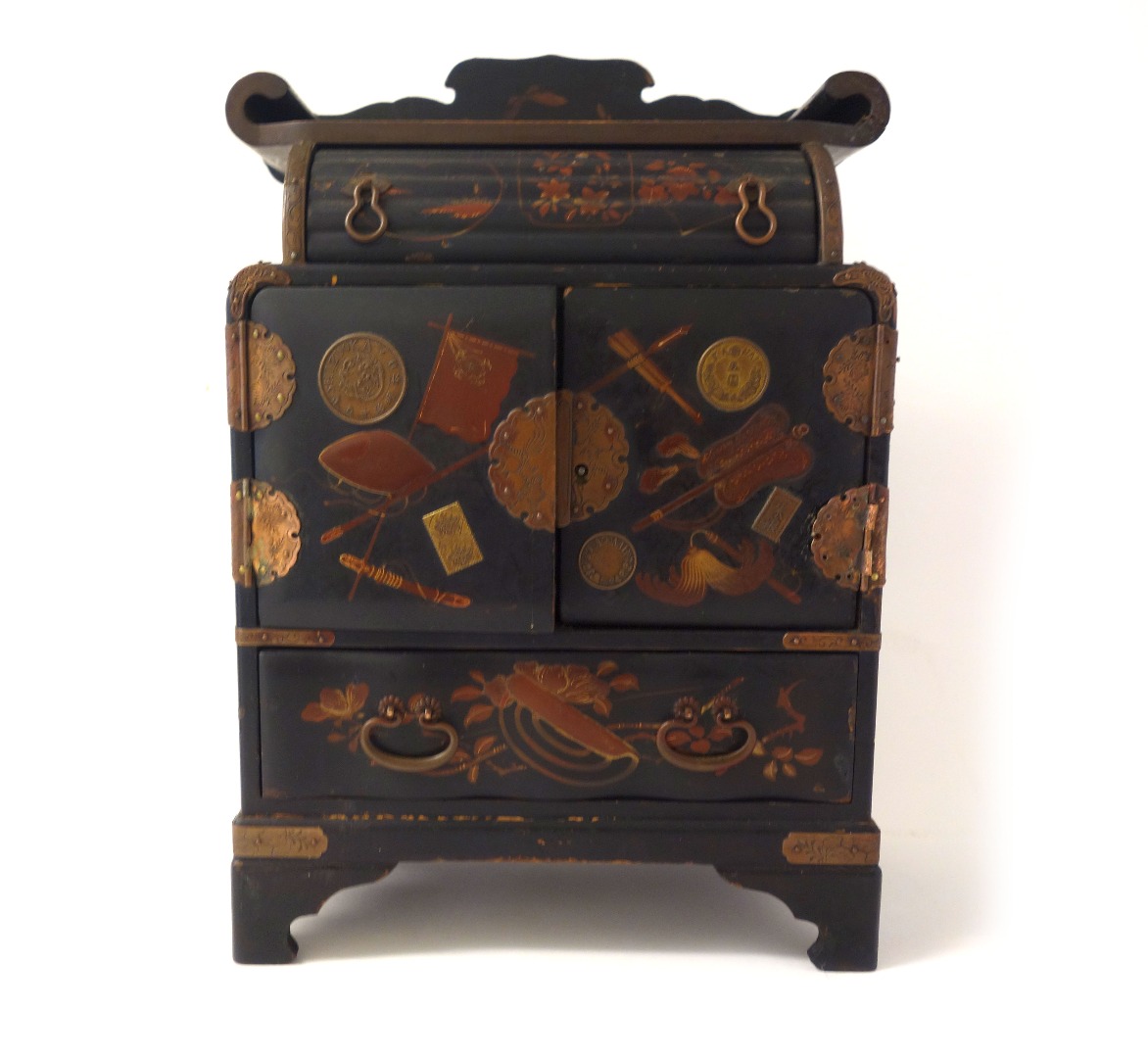 Appraisal: A Japanese miniature lacquered table cabinet with a pair of