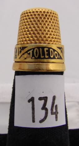 Appraisal: Gold tone thimble with decorative band marked Toledo