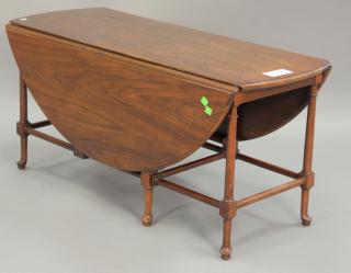 Appraisal: Baker walnut drop leaf coffee table with swing leg and