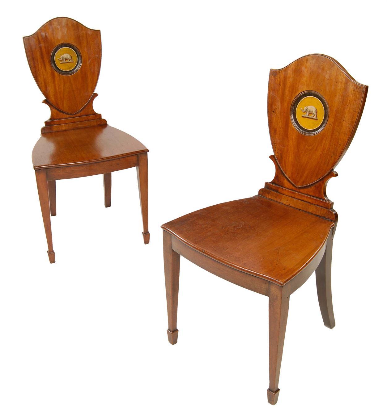 Appraisal: A pair of late George III mahogany hall chairs