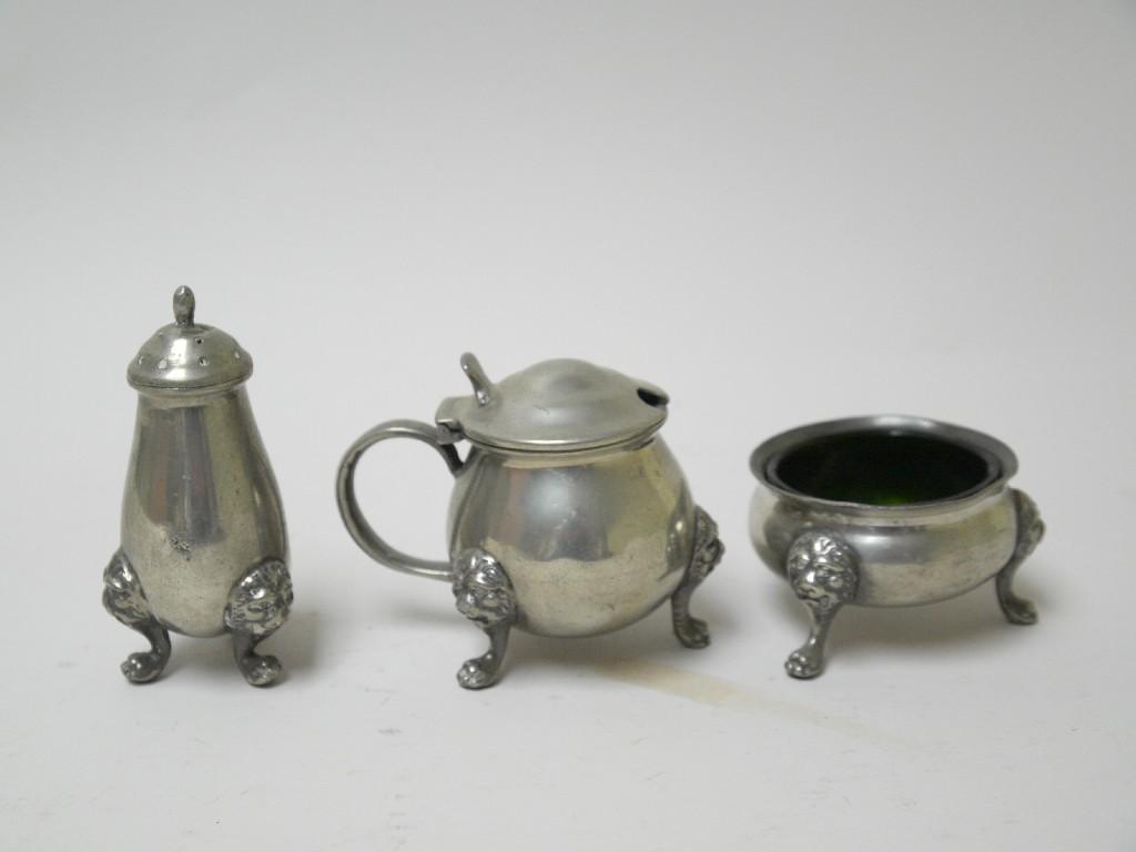 Appraisal: A Tudric pewter three piece Condiment Set with lion masks