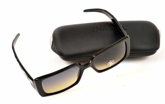 Appraisal: A PAIR OF SUNGLASSES BY CHANEL The rectangular black frames