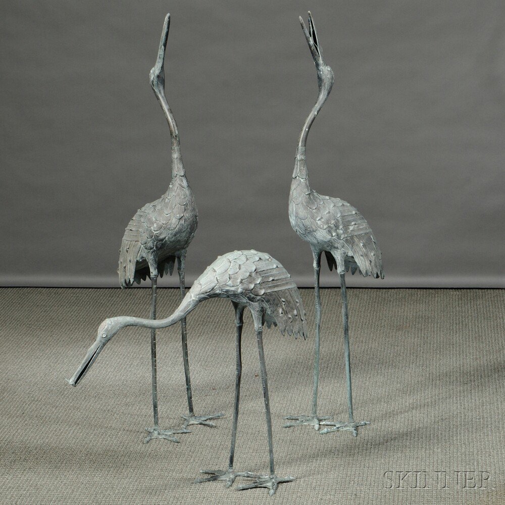 Appraisal: Standing Cranes Japan three patinated metal sculptures of cranes traces