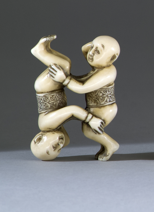 Appraisal: IVORY NETSUKE Early th CenturyIn the form of two infants