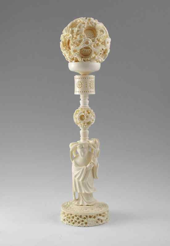 Appraisal: LARGE CARVED IVORY MYSTERY BALL ON FIGURAL STAND Carved and