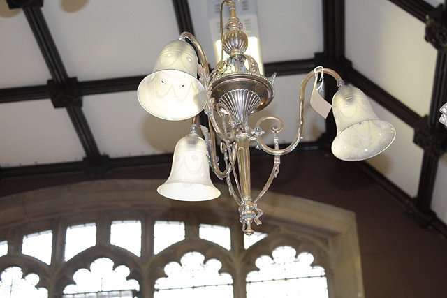 Appraisal: AN EDWARDIAN BRASS THREE BRANCH CENTRE LIGHT with foliate scroll