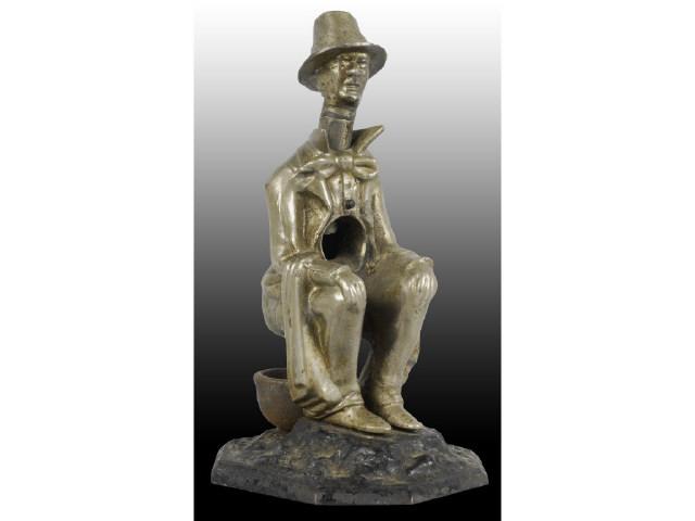 Appraisal: Seated Man on Chamber Pot Cigar Cutter Description Depressing hat